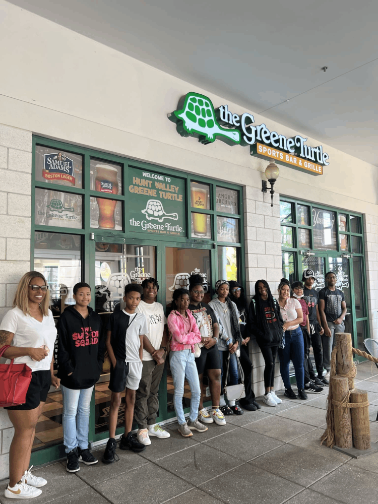 People standing outside the Greene Turtle store