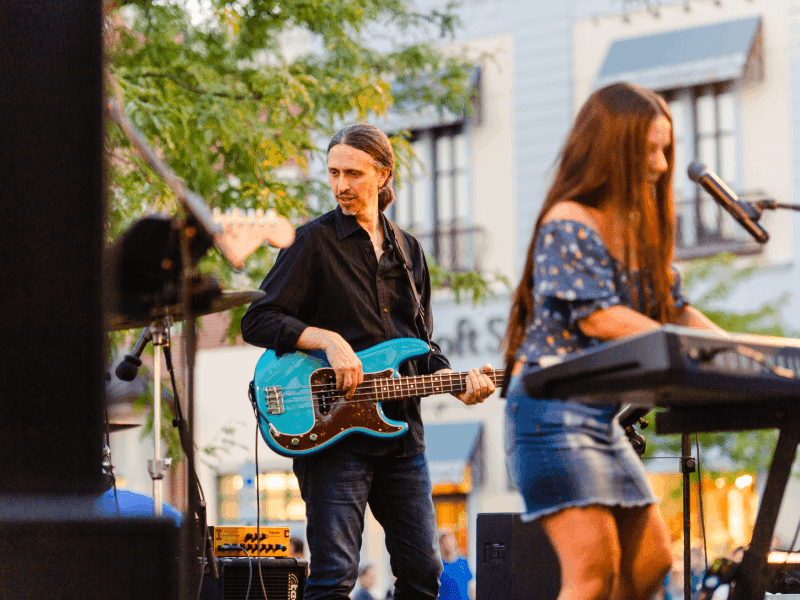 community events (1)-min Men playing guitar and girl playing keyboard at music event