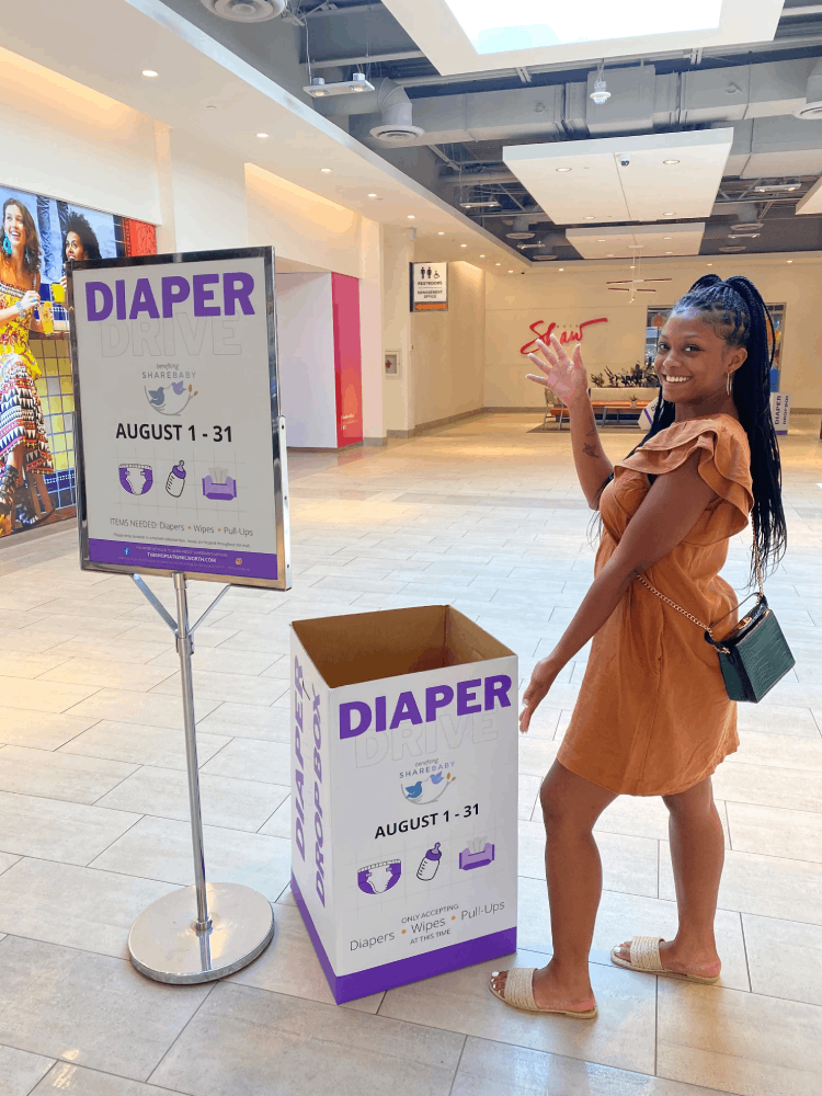 girl standing near donation box