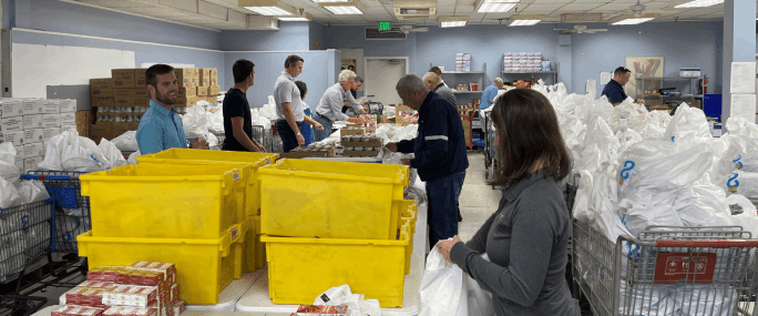 volunteer 684x285 (1)-min volunteer doing packaging
